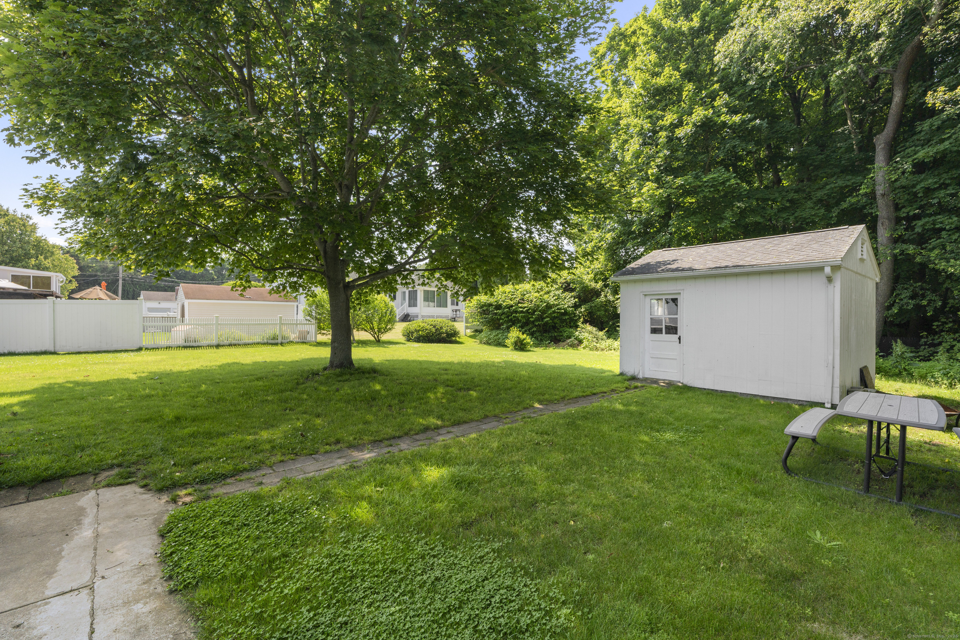 63 Johl Drive Groton, CT 06340 - Photo 32 of 40 a view of a backyard with a garden and trees