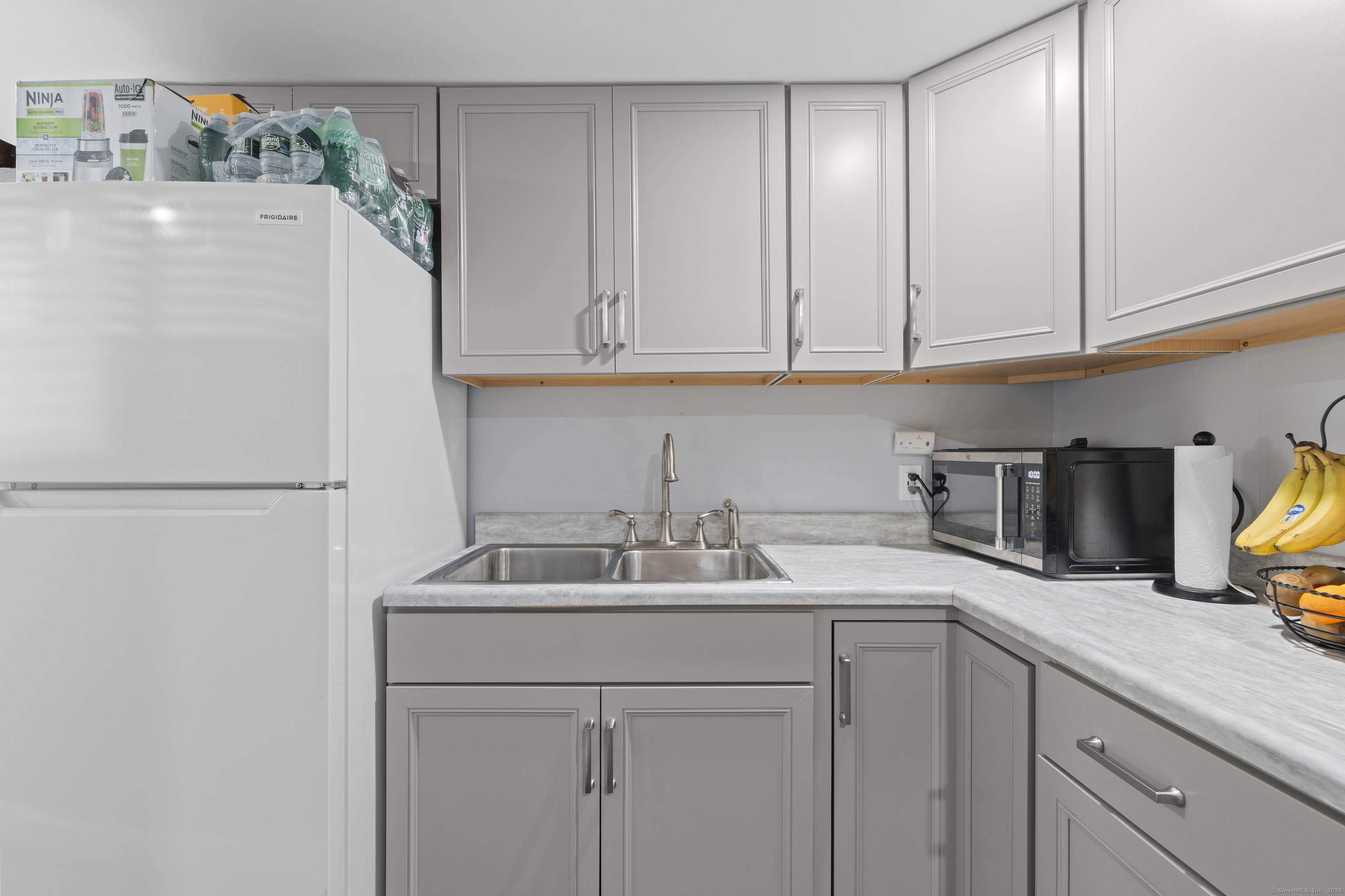 63 Johl Drive Groton, CT 06340 - Photo 34 of 40 a kitchen with a sink and a refrigerator