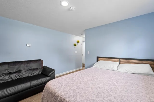 a bedroom with a bed and a dresser in it