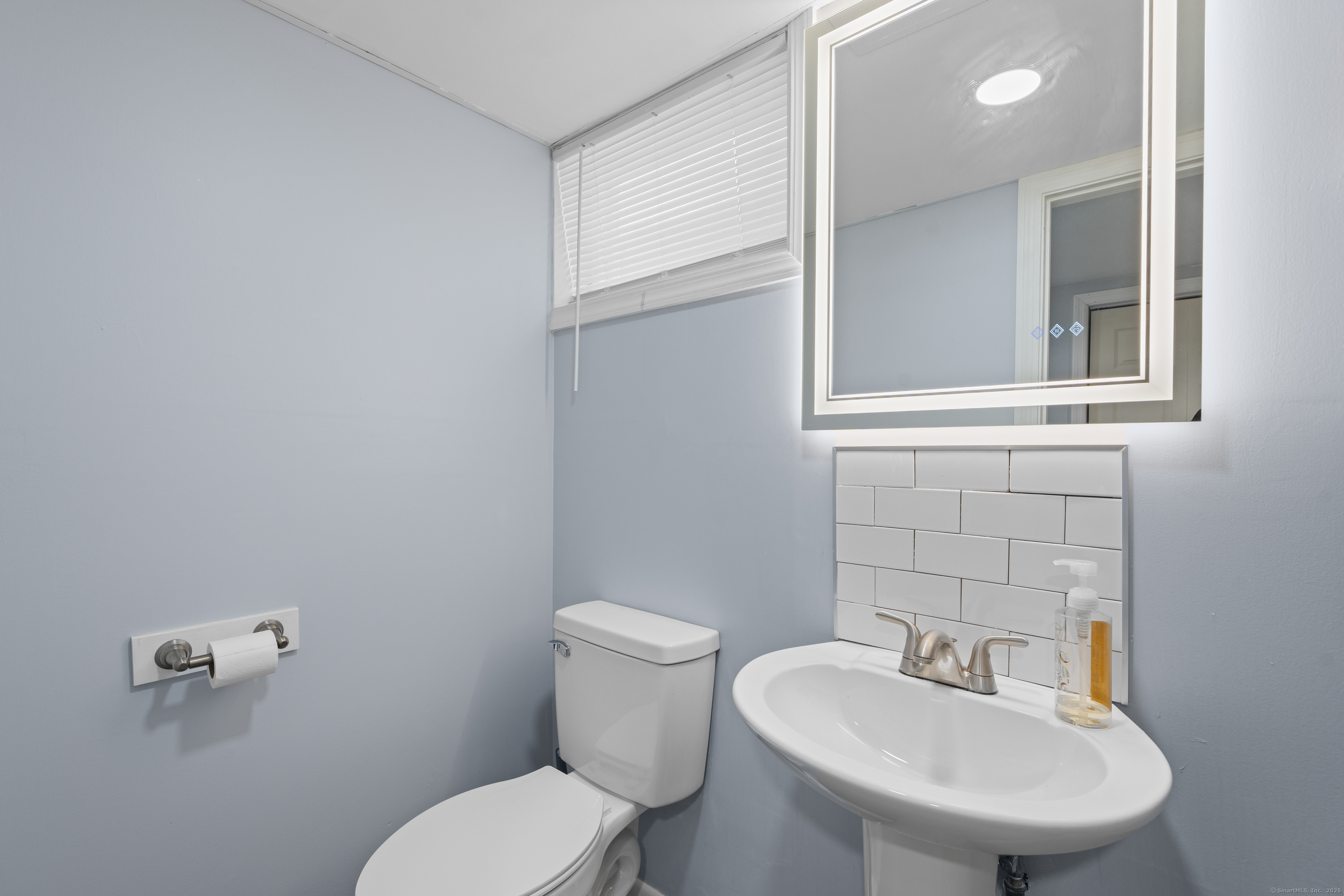 63 Johl Drive Groton, CT 06340 - Photo 39 of 40 a bathroom with a toilet sink and mirror