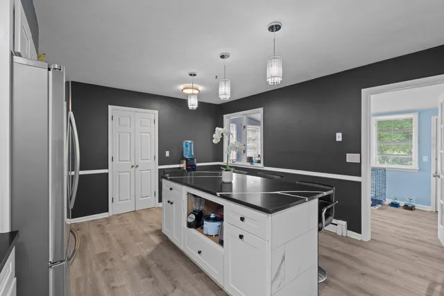 a kitchen with stainless steel appliances granite countertop a sink a refrigerator and a stove