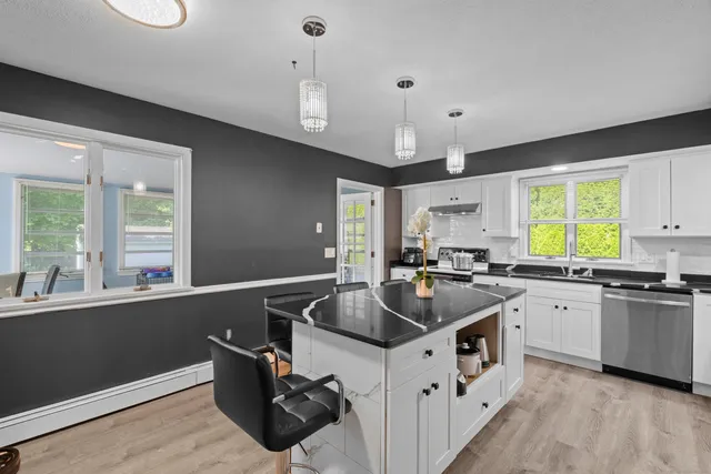 a kitchen that has a sink and a stove in it