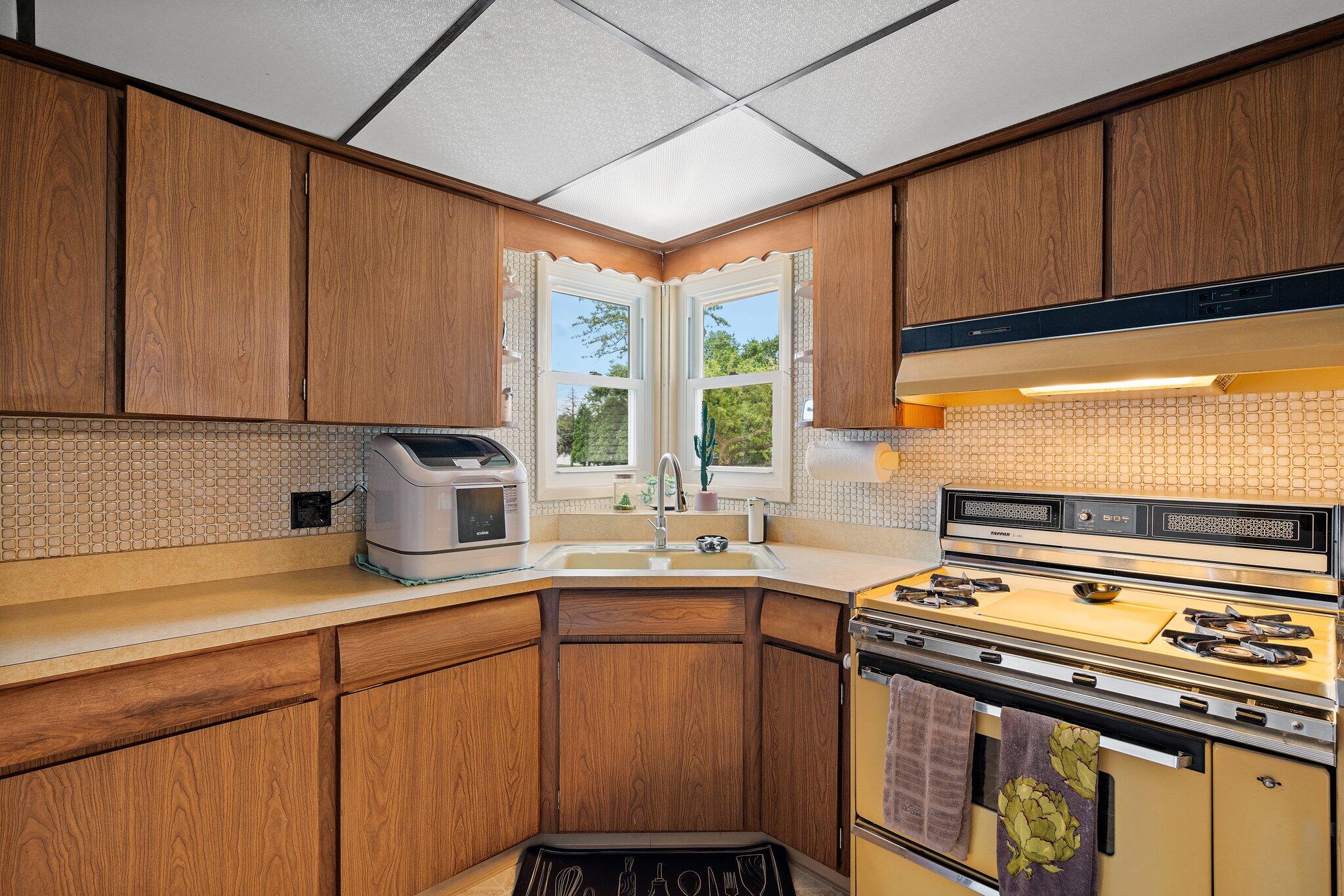 8014 Harrison Avenue Munster, IN 46321 - Photo 17 of 37 a kitchen with a sink stove and cabinets