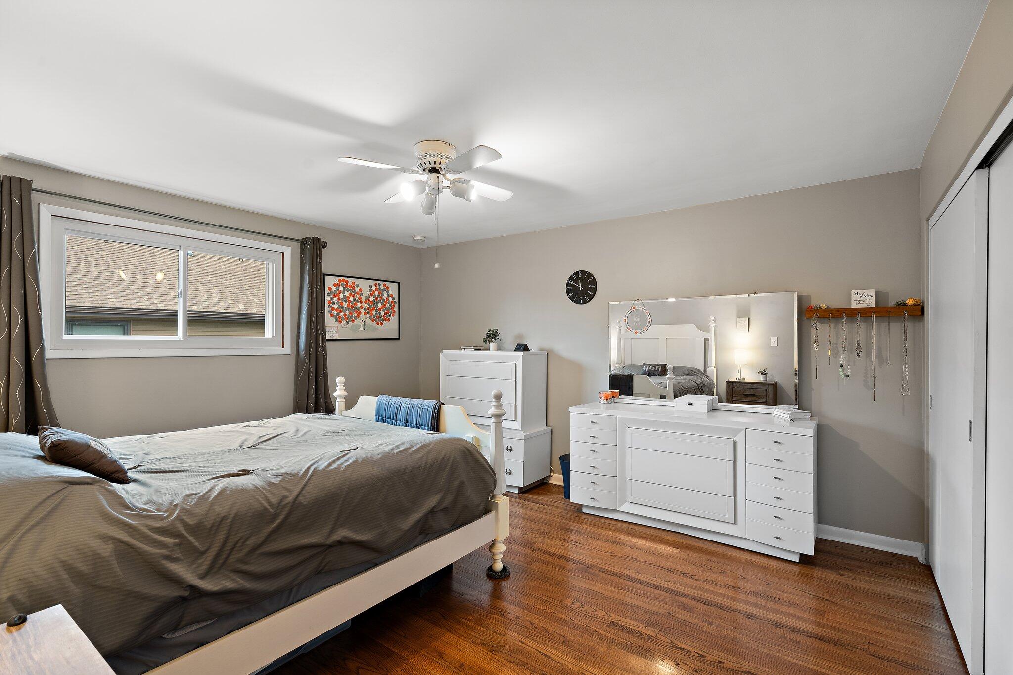 8014 Harrison Avenue Munster, IN 46321 - Photo 10 of 37 a bedroom with a bed and a chandelier
