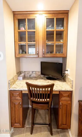 a dining room with a granite top table and chairs
