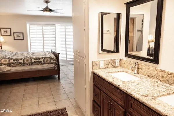 a en suite bathroom with a double vanity sink mirror and