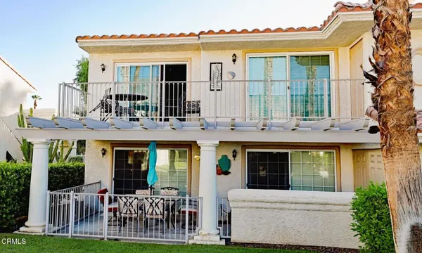 a view of a building with a porch and furniture