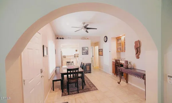 a view of a livingroom with furniture and a ceiling fan