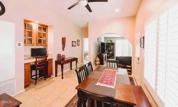 a view of a livingroom with furniture a rug a fireplace and wooden floor
