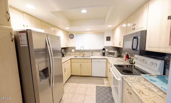 a kitchen with a refrigerator sink and microwave