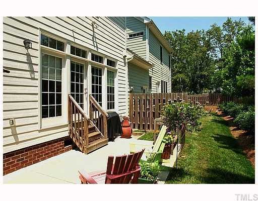2201 Tallon Hall Court, Unit 105 Raleigh, NC 27607 - Photo 12 of 12 a view of a house with backyard sitting area and garden