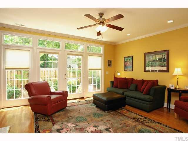 2201 Tallon Hall Court, Unit 105 Raleigh, NC 27607 - Photo 2 of 12 a living room with furniture a large window and a flat screen tv
