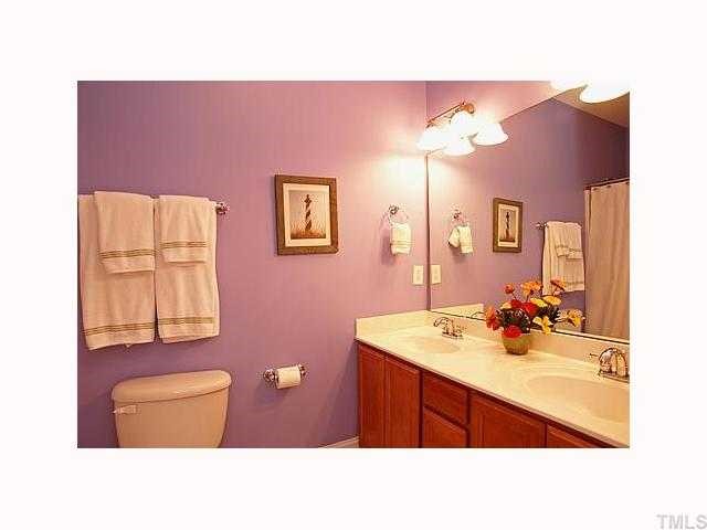 2201 Tallon Hall Court, Unit 105 Raleigh, NC 27607 - Photo 9 of 12 a bathroom with a sink vanity and a mirror