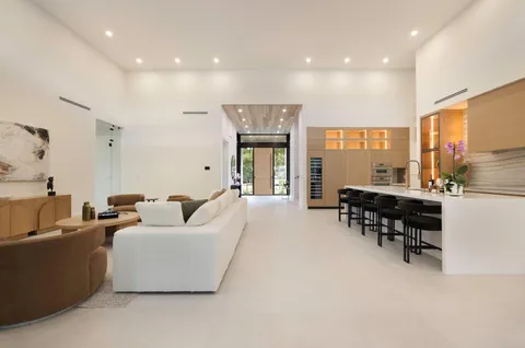 a dining room with furniture and a floor to ceiling window