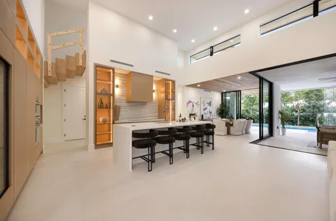 a dining room with furniture and a potted plant