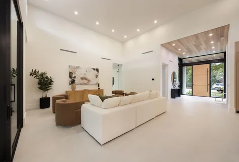 a large kitchen with kitchen island a large window
