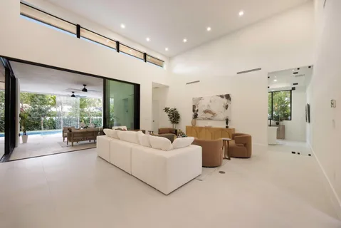 a spacious bedroom with a large bed and a large window