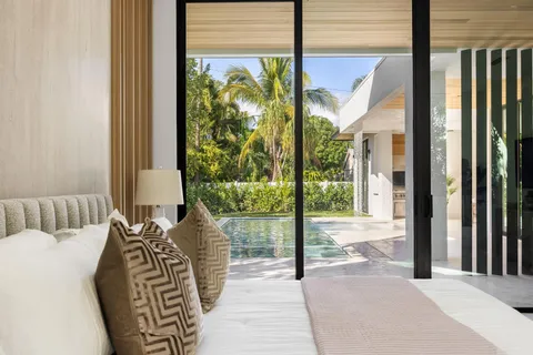 a living room with furniture a large window and a table