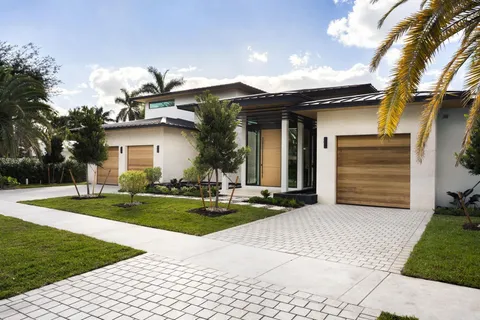 front view of a house with a yard and a garage