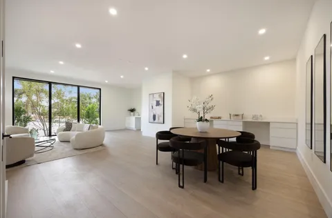 a living room with furniture a window and a potted plant