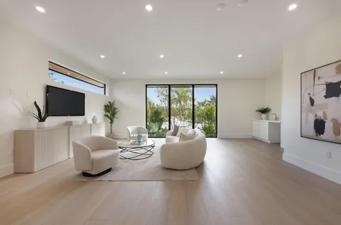 a bathroom with a granite countertop sink toilet and mirror