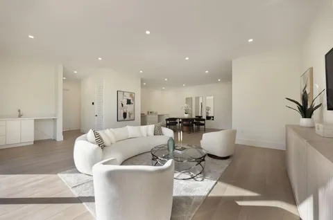 a bathroom with a granite countertop sink toilet mirror and shower