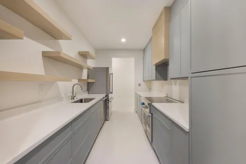 a dining room with furniture and a large window