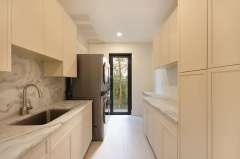 a living room with furniture a flat screen tv and a potted plant