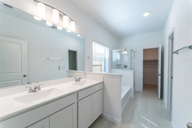 a spacious bathroom with a double vanity sink mirror and double