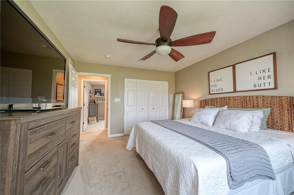 667 Ridge Road Georgetown, PA 15043 - Photo 17 of 27 a bedroom with a large bed and a chandelier