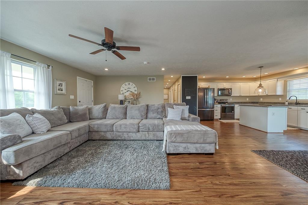 667 Ridge Road Georgetown, PA 15043 - Photo 4 of 27 a living room with furniture wooden floor and a kitchen view