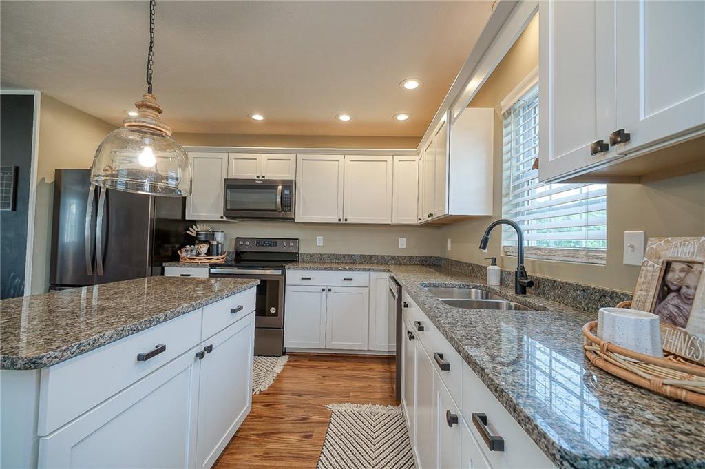 667 Ridge Road Georgetown, PA 15043 - Photo 6 of 27 a kitchen with stainless steel appliances granite countertop a sink stove and refrigerator