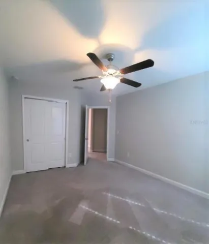 a bathroom with a granite countertop sink a toilet and a mirror