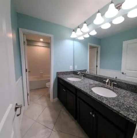 an empty room with a ceiling fan and window