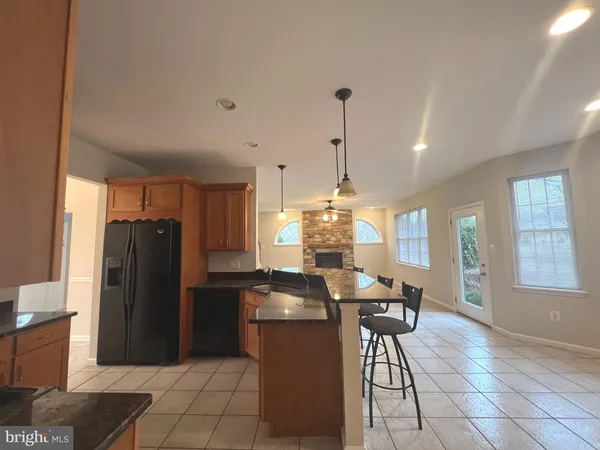a kitchen with a refrigerator a table and chairs