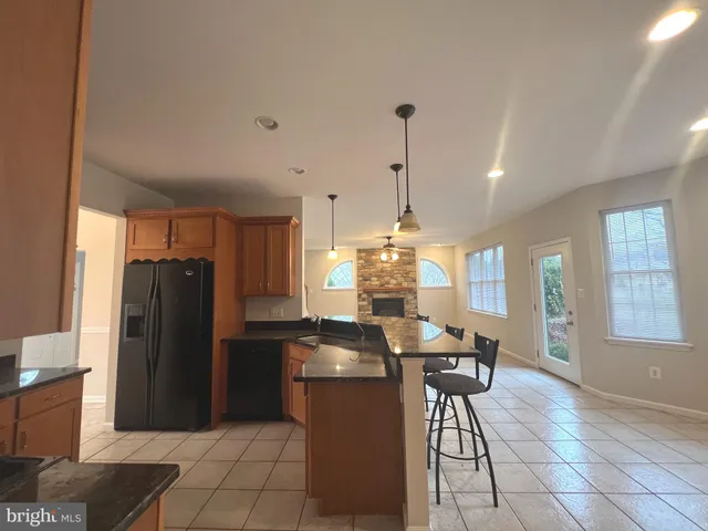 a kitchen with a refrigerator a table and chairs