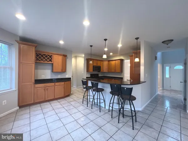 a kitchen with stainless steel appliances kitchen island granite countertop a sink and cabinets