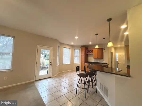 a living room with furniture a dining table and a large window