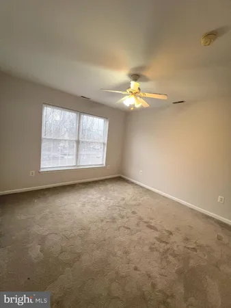 an empty room with a empty space and windows