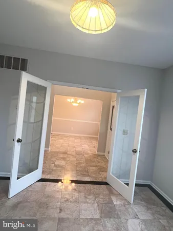 an empty room with wooden floor and a table