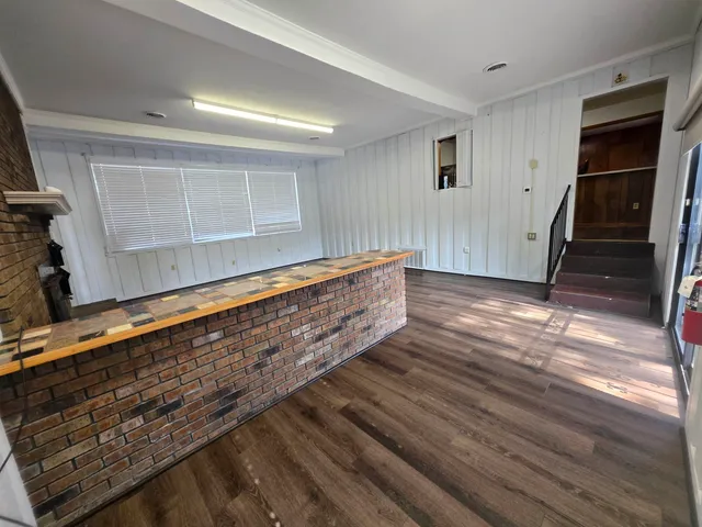 a living room with hard wood floors and a window