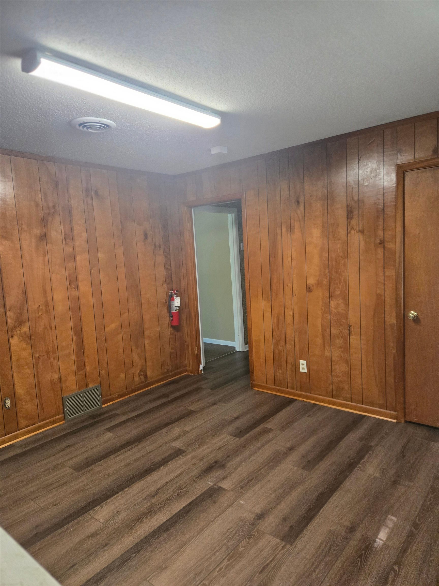 6855 Raleigh Lagrange Road Memphis, TN 38134 - Photo 6 of 13 an empty room with wooden floor and windows