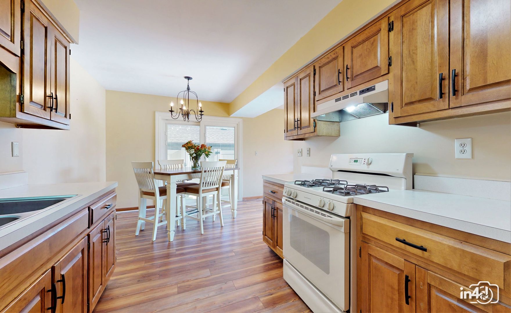 272 Circlegate Road New Lenox, IL 60451 - Photo 12 of 24 a kitchen with stainless steel appliances granite countertop a stove a sink dishwasher and white cabinets with wooden floor