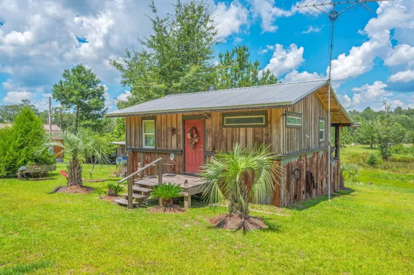 a view of a house with a yard porch and sitting area