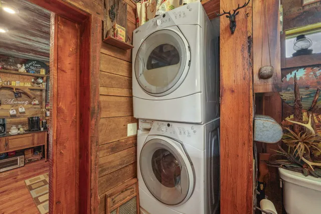 a view of a dining room with furniture large windows and wooden floor
