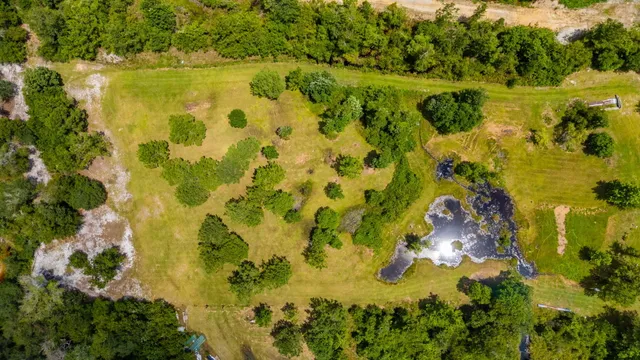 a backyard of a house with yard table and chairs