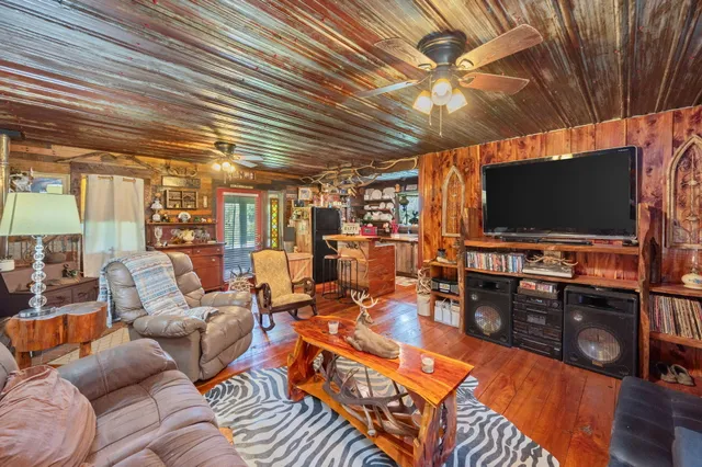 a kitchen with a stove and a wooden floor