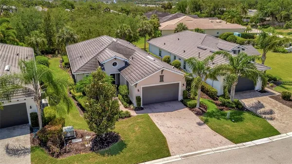 an aerial view of a house with yard swimming pool and outdoor seating