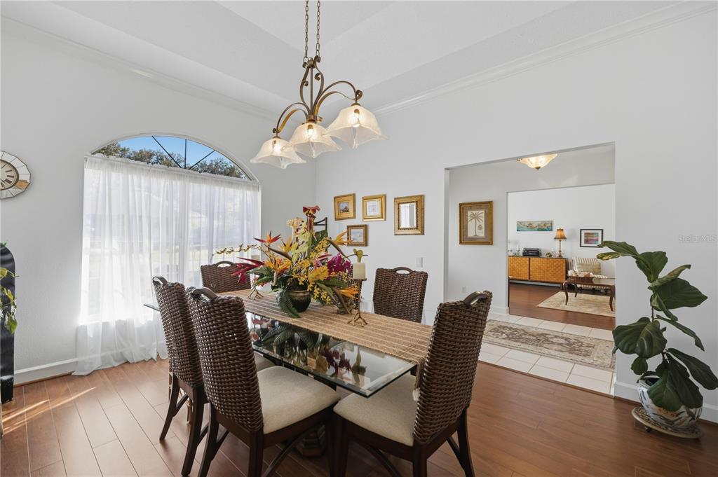 700 Southwest 89th Terrace Ocala, FL 34481 - Photo 11 of 94 a view of a dining room with furniture wooden floor and chandelier