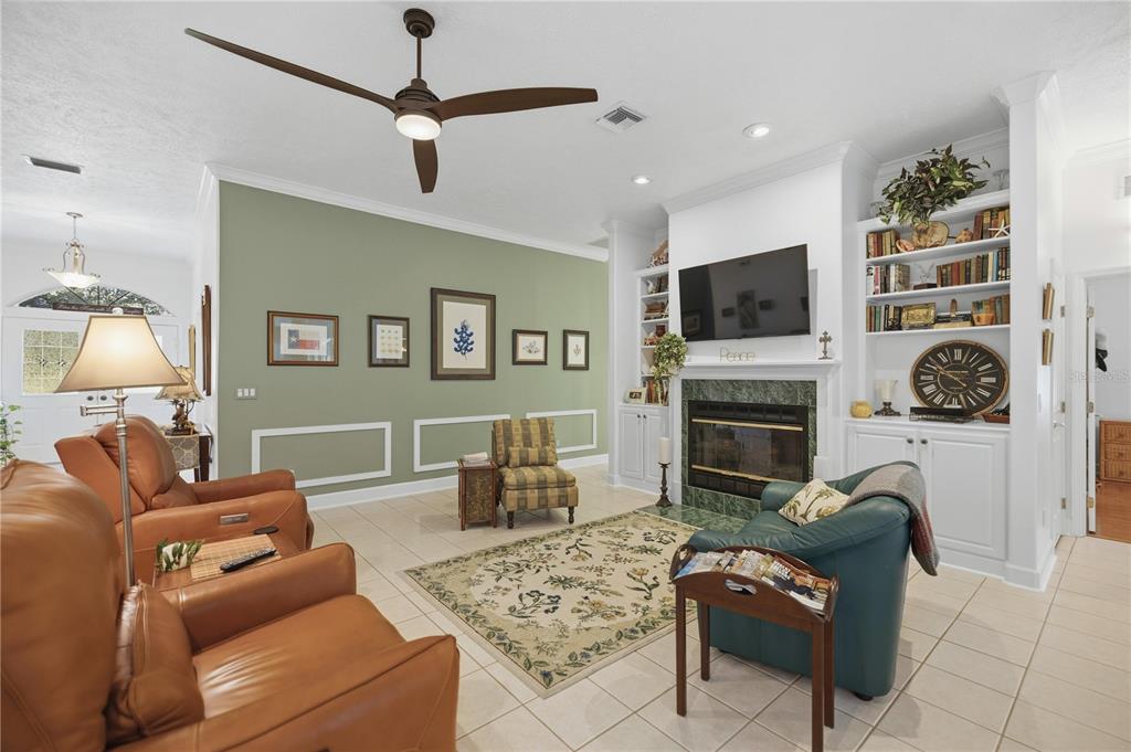 700 Southwest 89th Terrace Ocala, FL 34481 - Photo 18 of 94 a living room with furniture a flat screen tv and a fireplace
